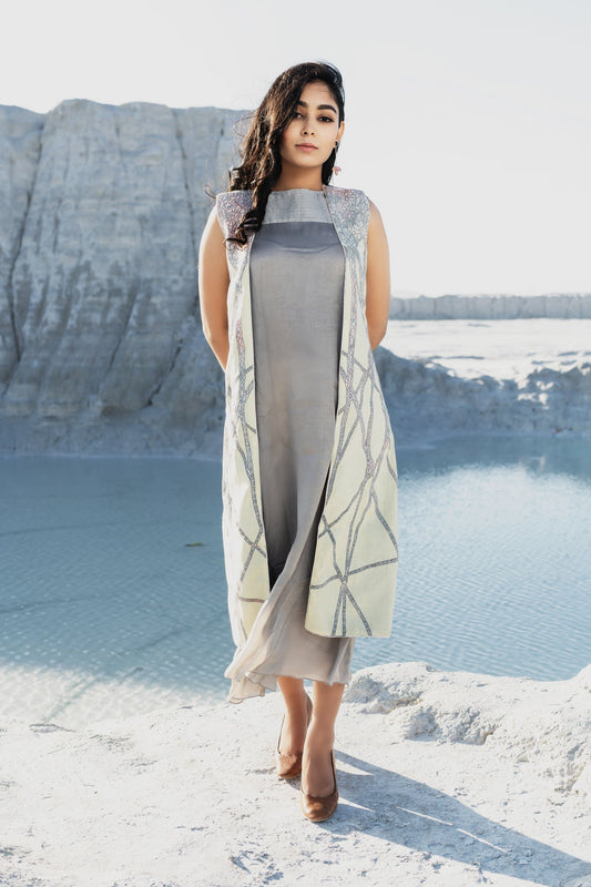 Grey dress with pleat details paired with sleeveless embroidered coal - Label Manasi